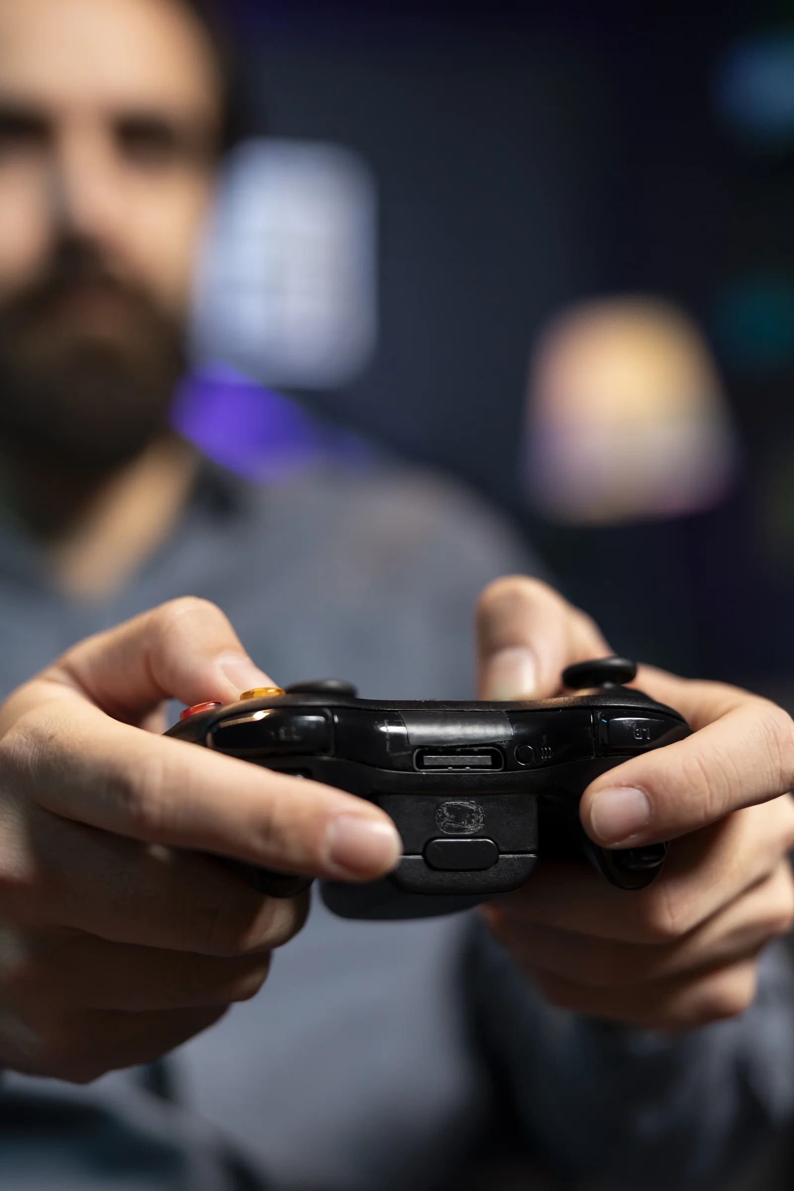 focus shot controller held by man defeating enemies while playing videogames