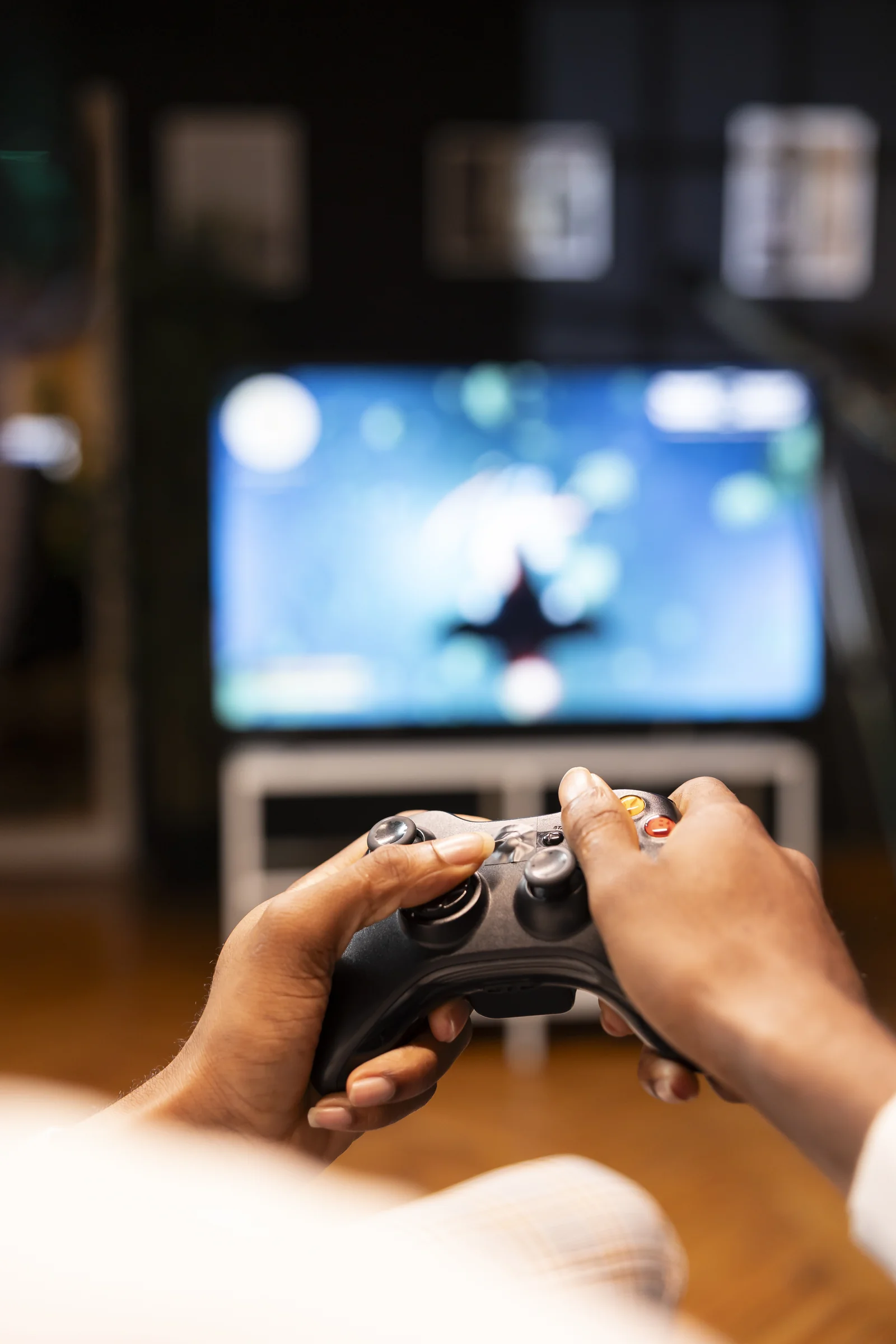 focus shot man holding controller apartment playing videogames smart tv display