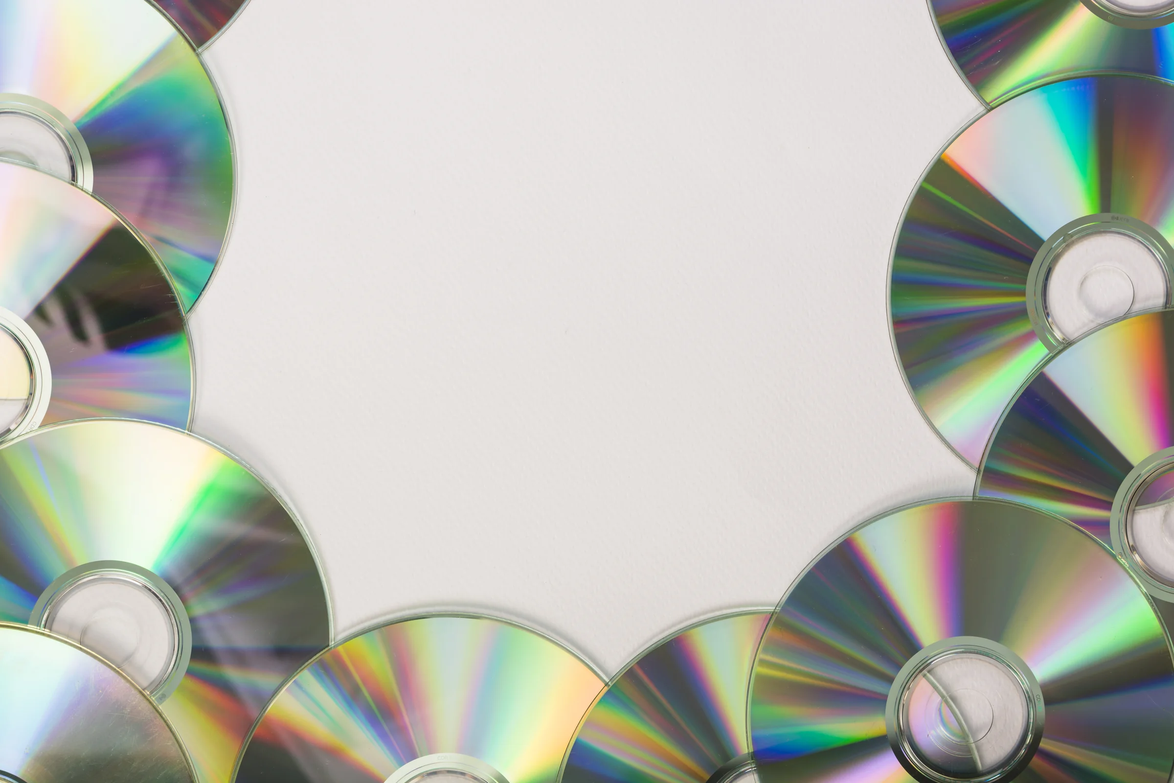 many compact discs with space text white background